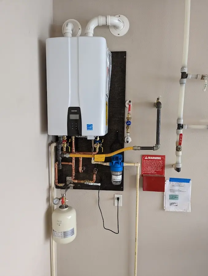 Professional plumber installing copper piping in a Orange Park home